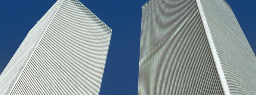 The Twin Towers of the World Trade Center seen from below against a clear blue sky